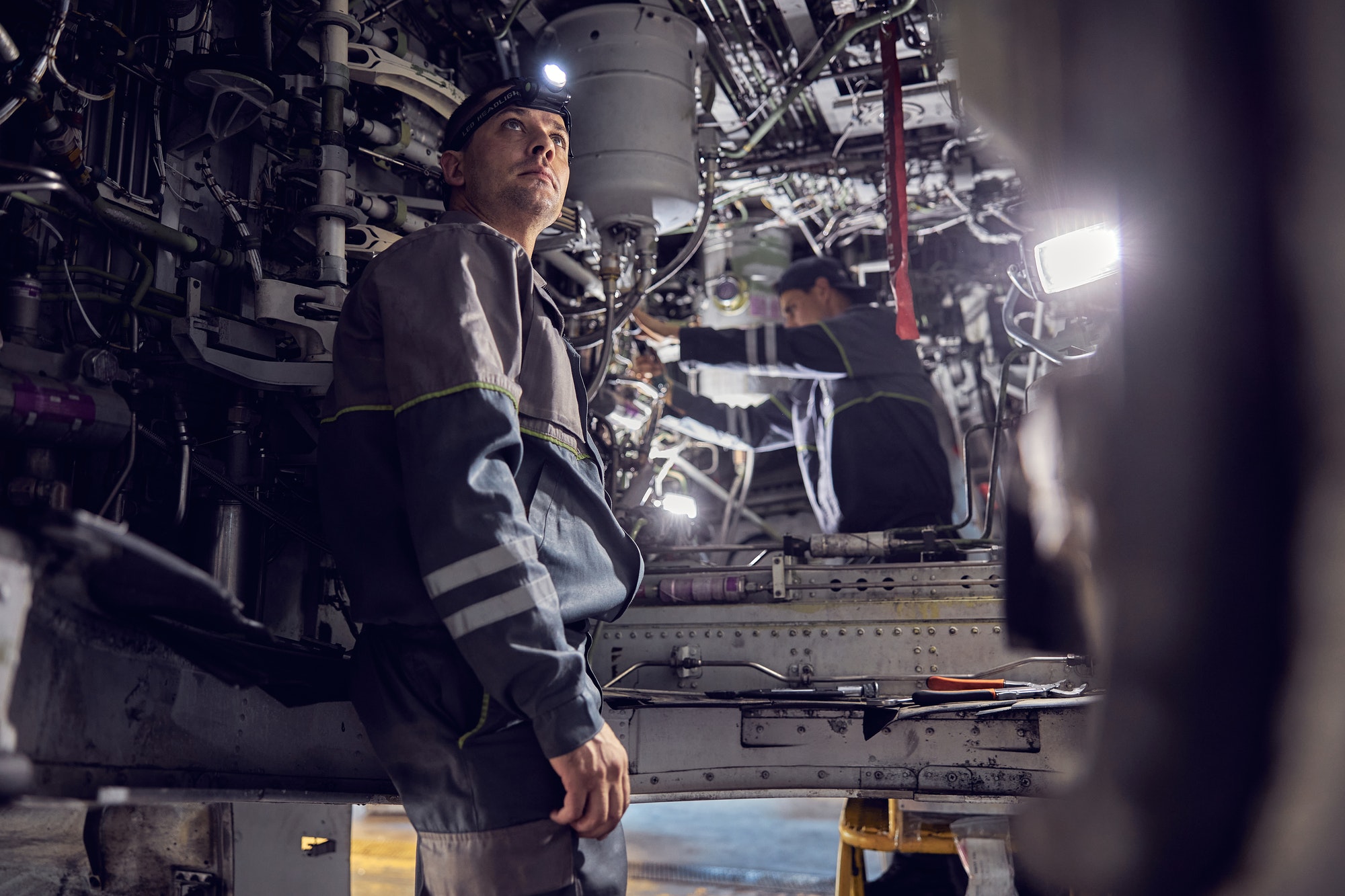 Mechanic is working on aircraft with system